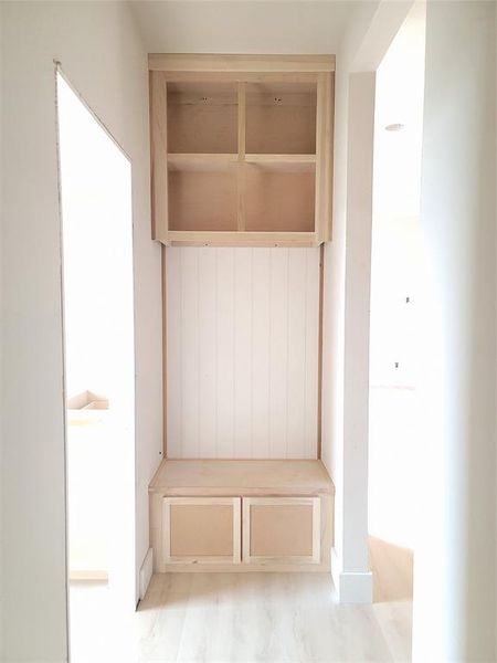 Mudroom, drop station, shiplap walling, and custom cabinets