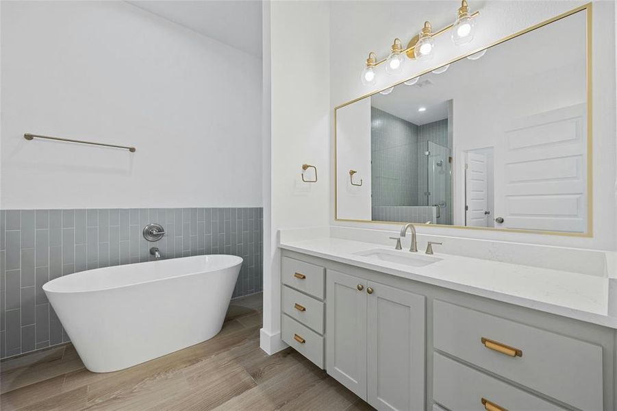 Primary bathroom with separate tub and step in shower.