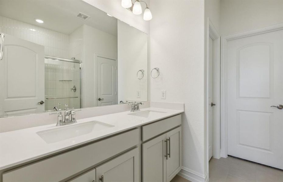 Spacious owner's bathroom with dual vanity *real home pictured