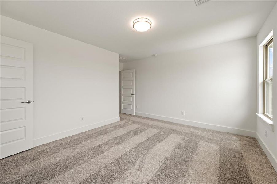 Spare room featuring light colored carpet