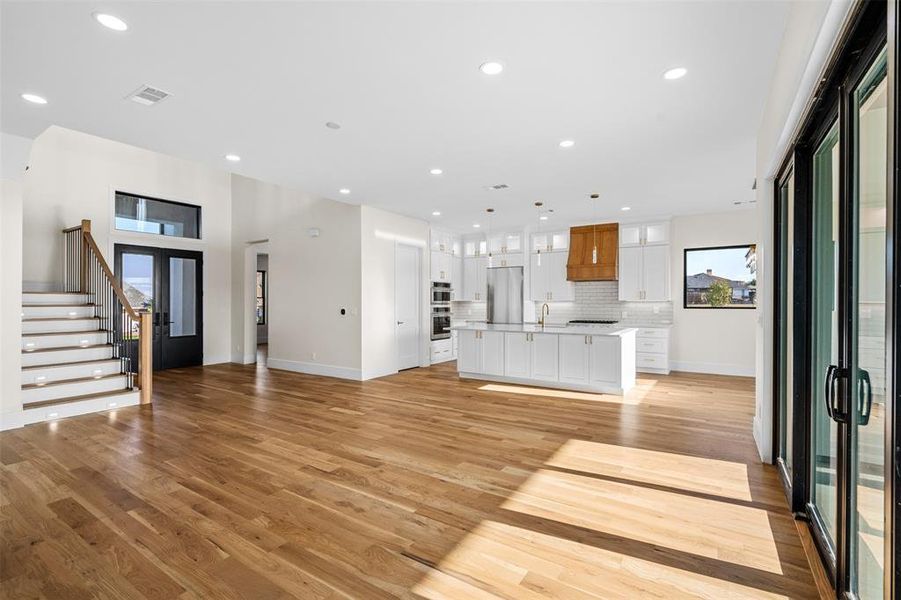 Unfurnished living room with plenty of natural light and light hardwood / wood-style flooring