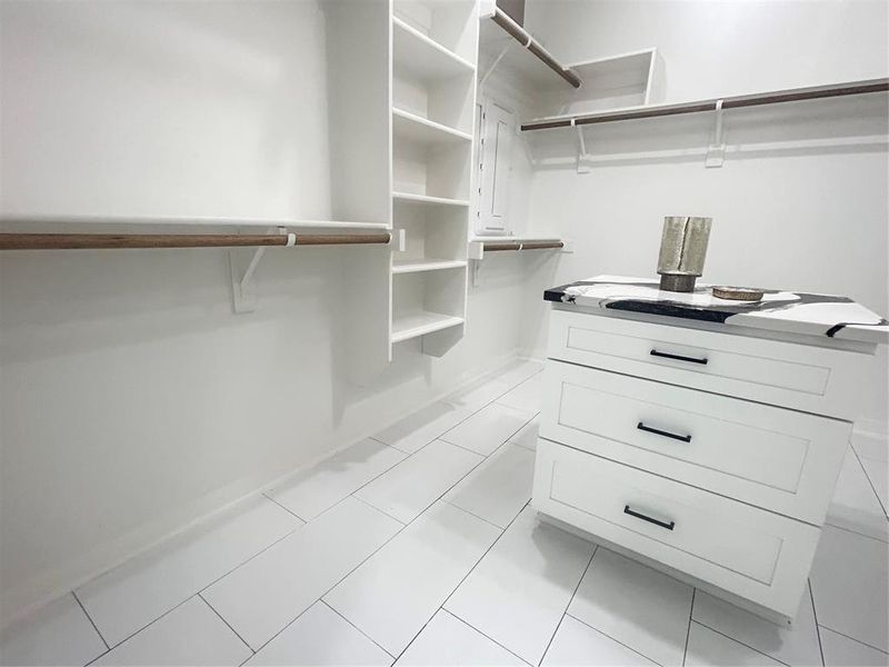 Spacious closet with light tile patterned flooring