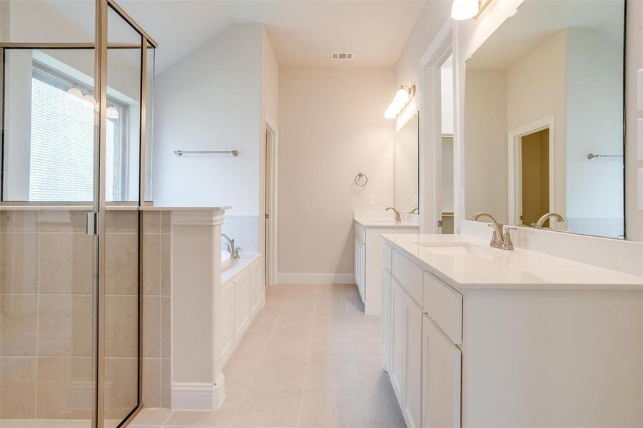 Bathroom with plus walk in shower, vanity, and tile patterned floors