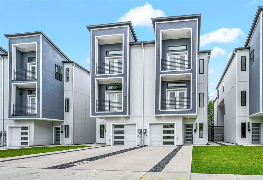 View of front of house featuring a balcony and a garage