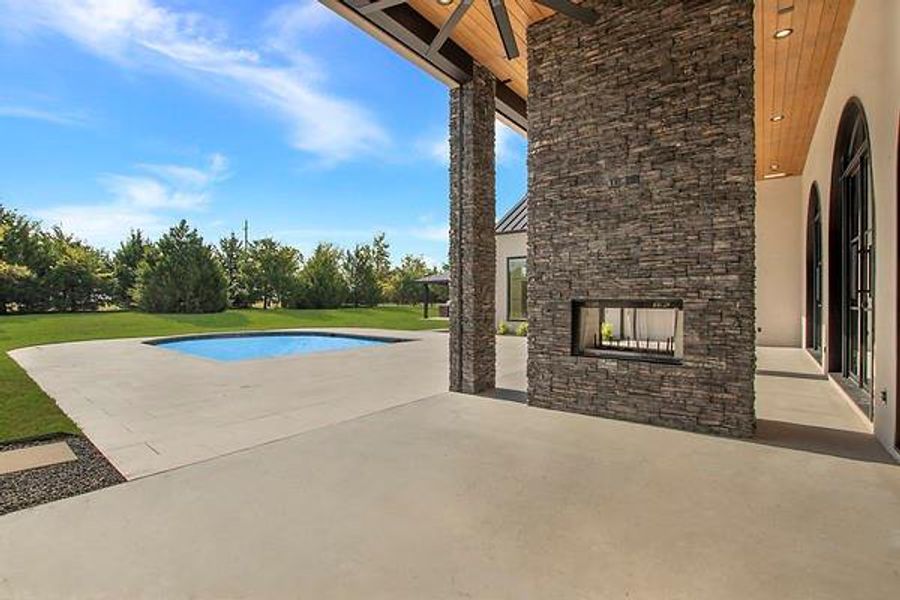 View of pool with a patio area and a lawn