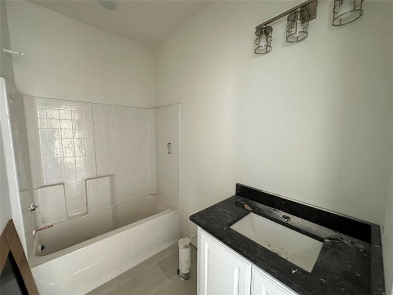 Bathroom featuring  shower combination and vanity