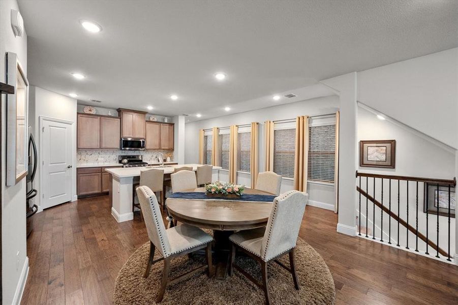 Dining space with dark wood-type flooring