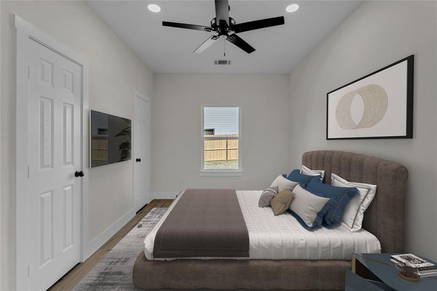 Bedroom with ceiling fan and hardwood / wood-style floors