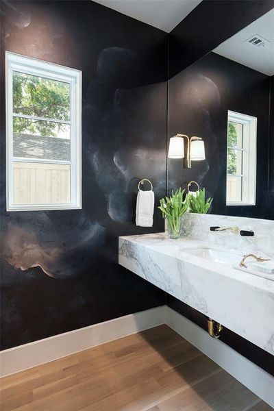 Bathroom with hardwood / wood-style flooring, plenty of natural light, and vanity