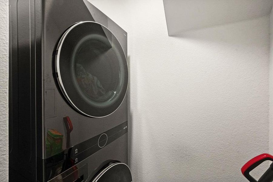 Clothes washing area featuring stacked washer / dryer