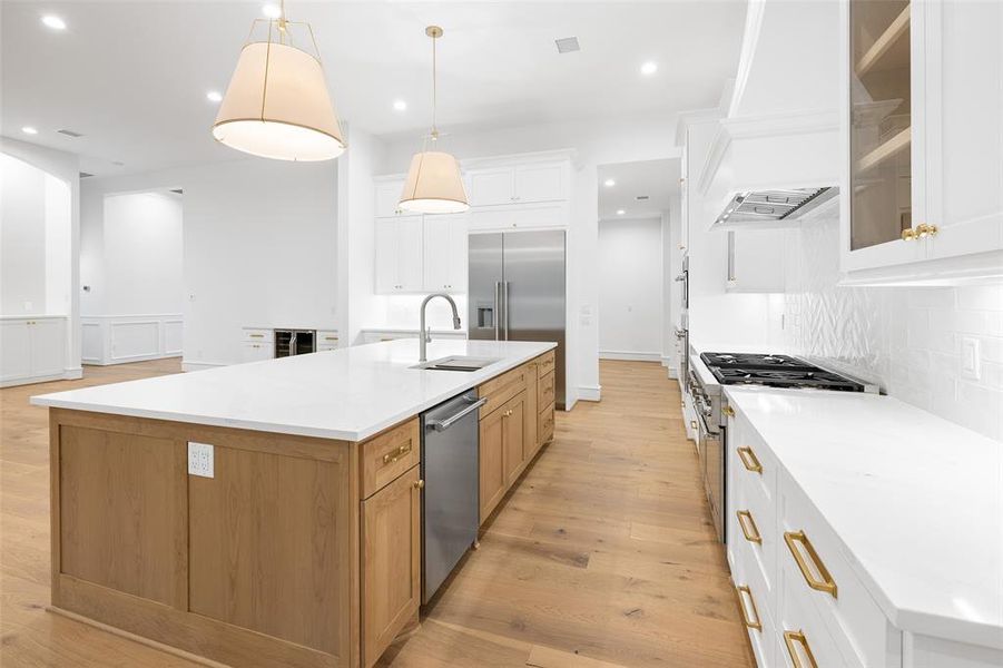 With white custom cabinetry throughout and quartz countertops, this Kitchen is gorgeous!