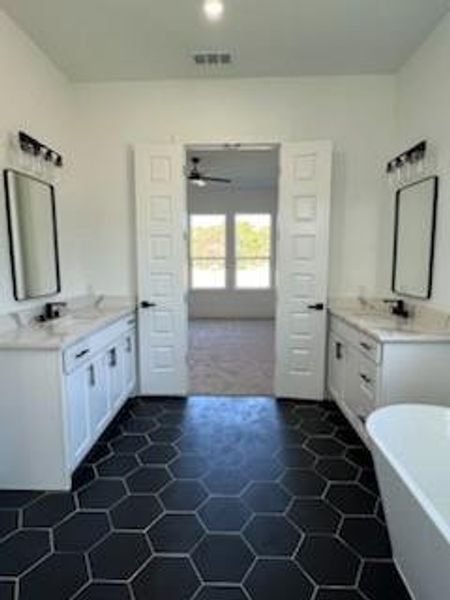 Bathroom featuring a bathing tub, ceiling fan, tile patterned flooring, and vanity