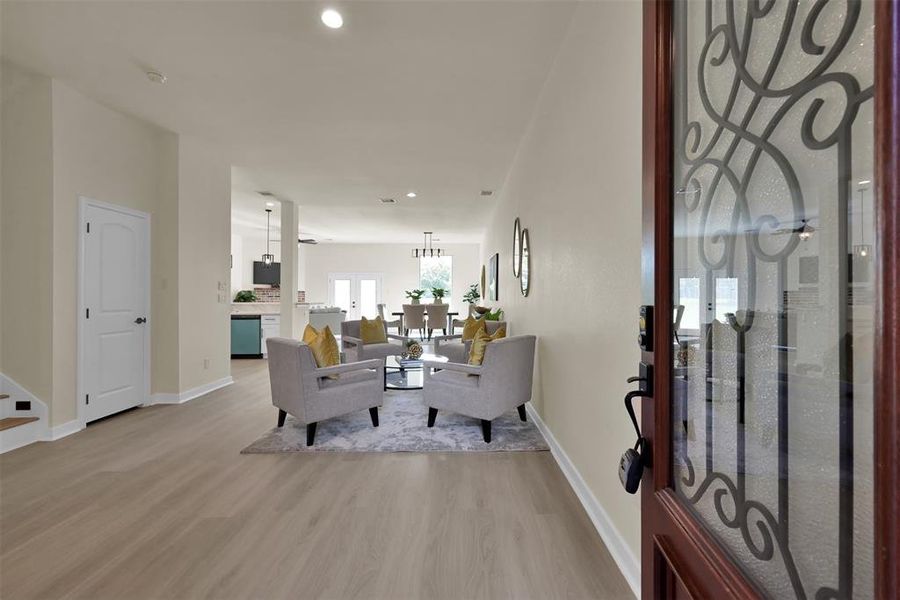 The entrance to the home opens up to a large living/dining space that is bright with natural light.