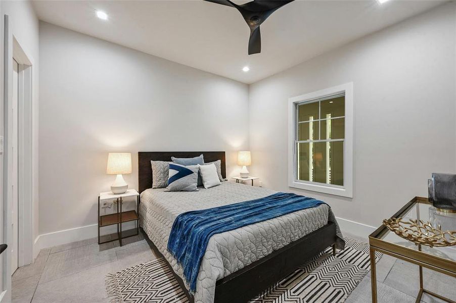 Bedroom one on the first floor offers a comfortable retreat with a ceiling fan to keep the air circulating and a window that welcomes natural light. It can also be easily converted into a home office.