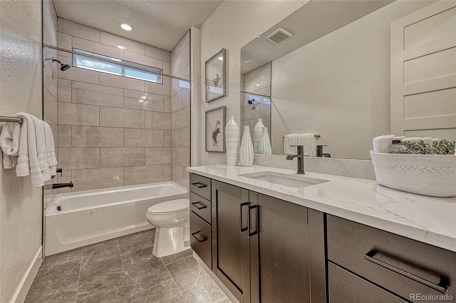 A bathroom is found centrally located on the main level. Enjoy the tile flooring, single vanity with plenty of cabinetry and a spacious shower/tub combo. How perfect!