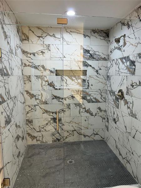 Bathroom featuring tiled shower