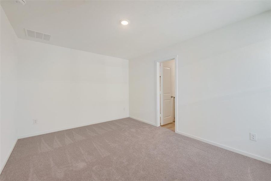 Unfurnished room featuring light colored carpet