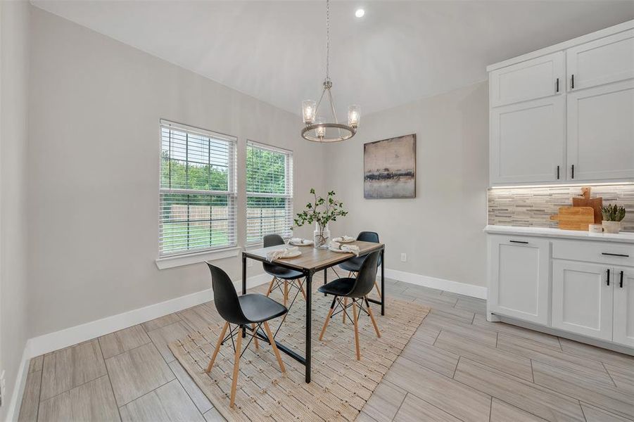 Dining area featuring a chandelier and light tile patterned floors