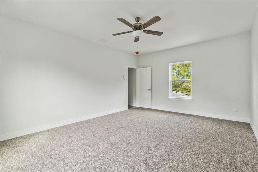 Spare room featuring ceiling fan and carpet floors