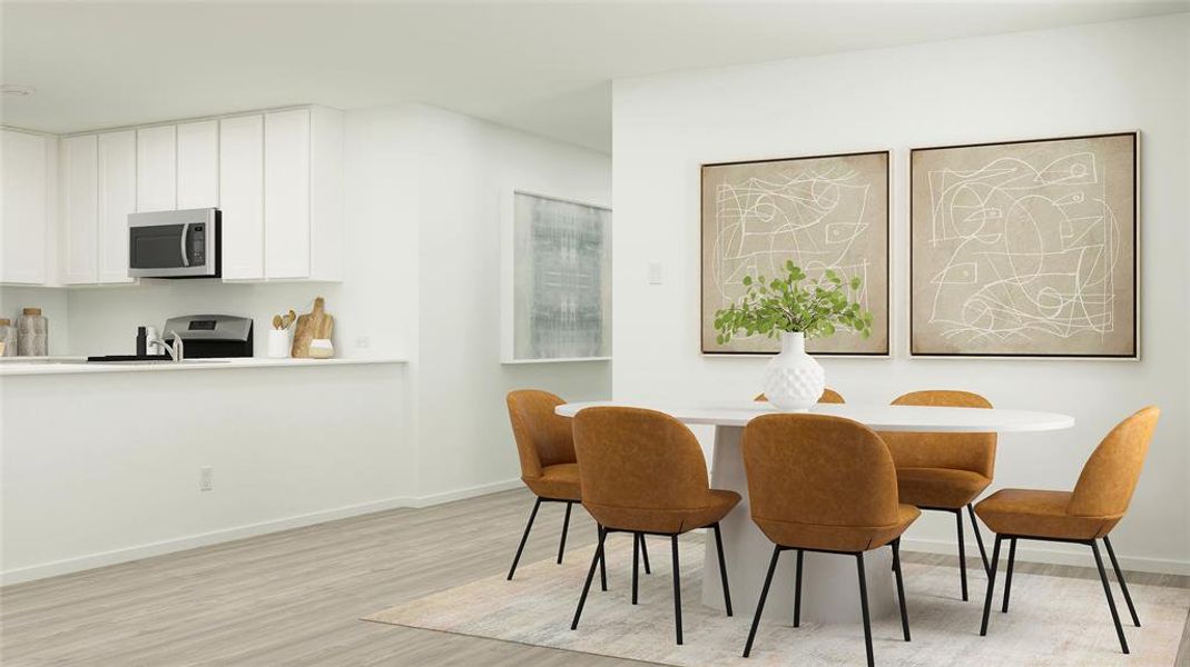 Dining space with sink and light hardwood / wood-style flooring