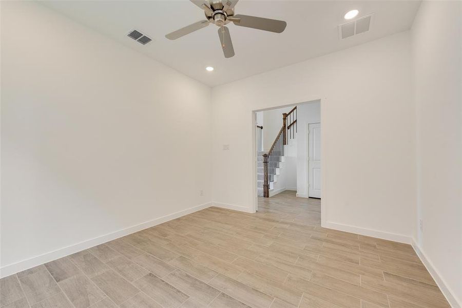 Spare room with light hardwood / wood-style floors and ceiling fan