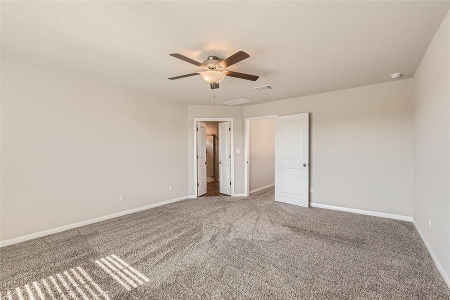 This large primary suite is secluded away from the secondary bedrooms and offers plenty of space for a king sized bed, furniture, a seating area, and more!