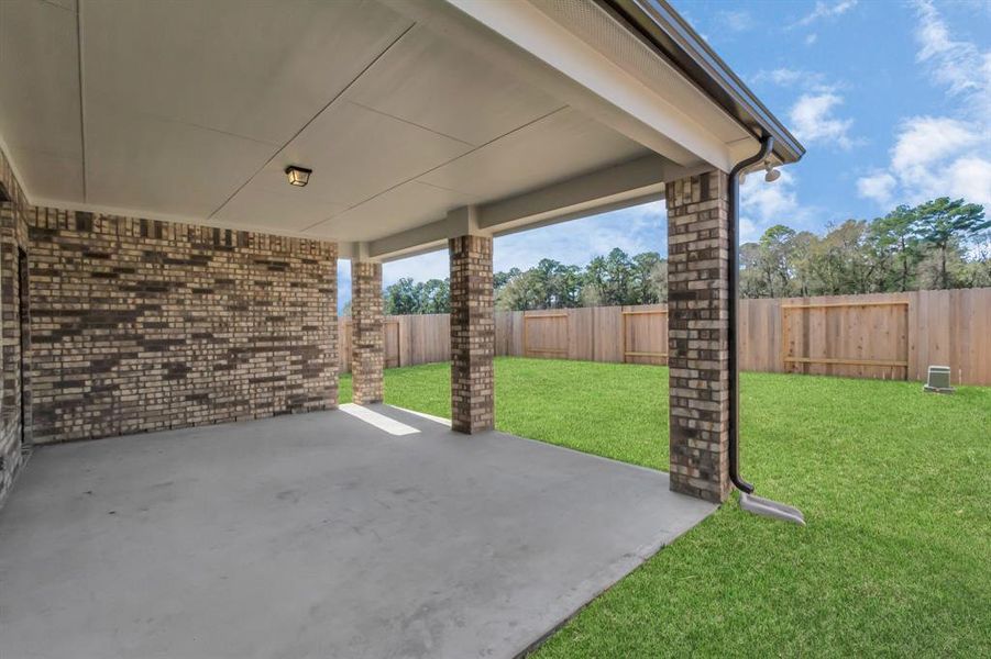 Experience outdoor living at its finest on this expansive covered patio, thoughtfully designed for BBQs and delightful outdoor dining. Sample photo of completed home with similar floor plan. As built color and selections may vary.