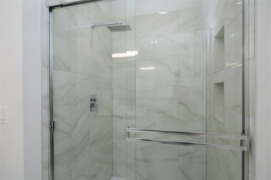 Bathroom featuring a shower with door