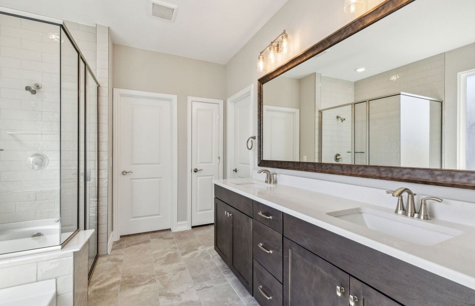 Elegant owner's bathroom with dual vanity and oversized shower