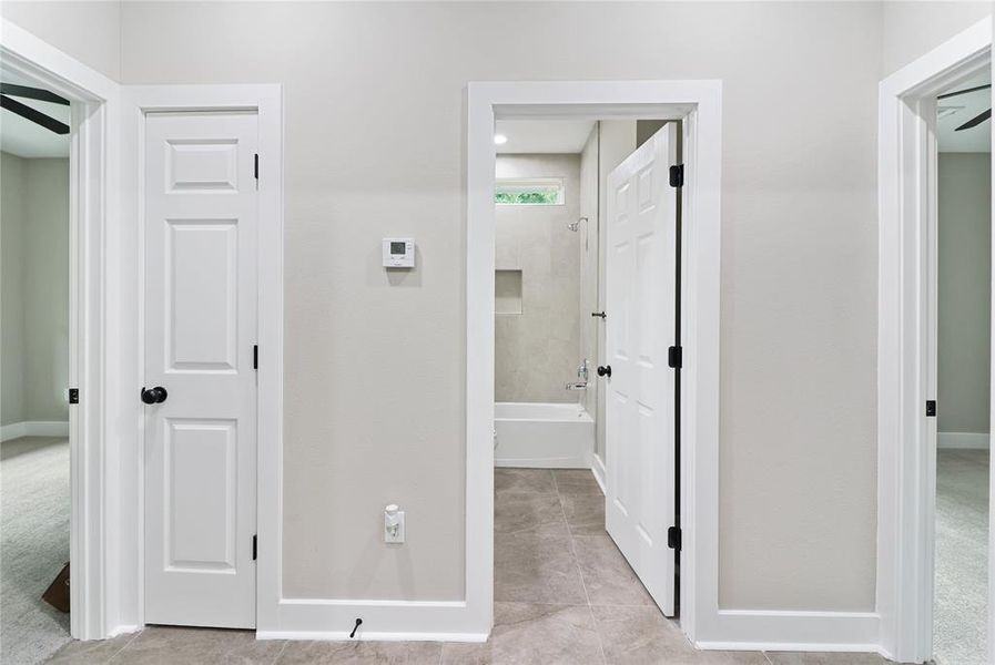 View of the hallway to secondary bedrooms, bath, and storage closet