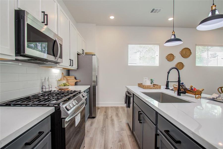 Stainless Steel Appliances, Subway tile Backsplash & Quartz Counter Tops. Model home photos - FINISHES AND LAYOUT MAY VARY! Ceiling fans are NOT INCLUDED!
