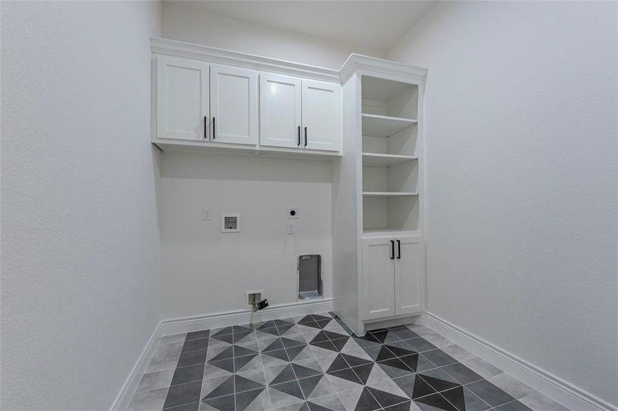 Utility room with tile floor and built in storage