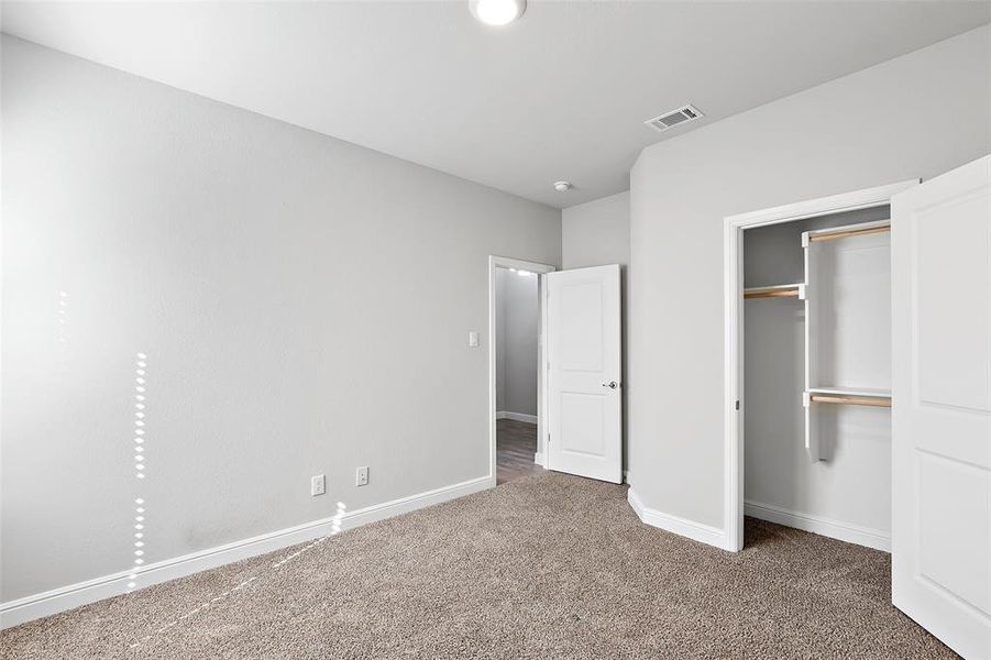 Unfurnished bedroom with a closet and carpet flooring