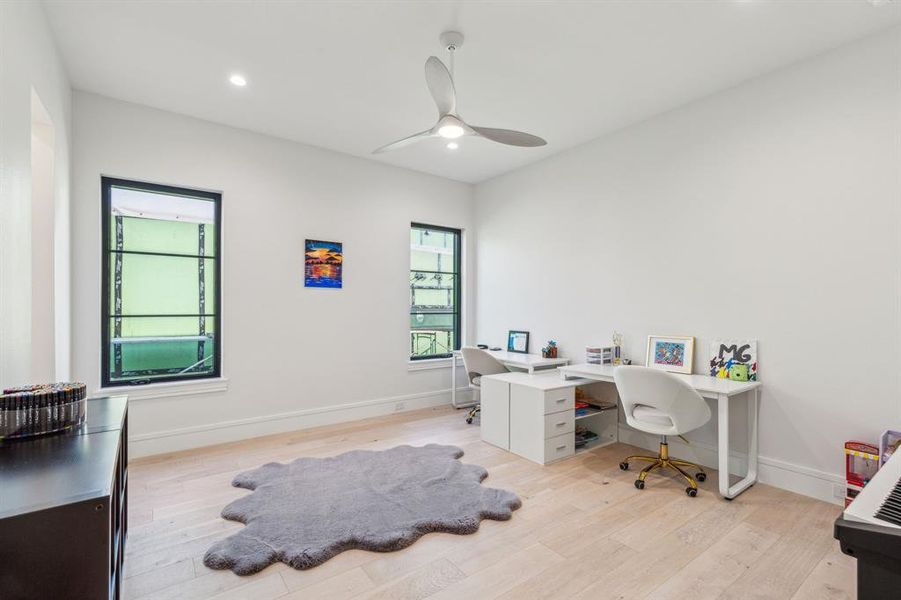 Home office featuring light hardwood / wood-style flooring and ceiling fan