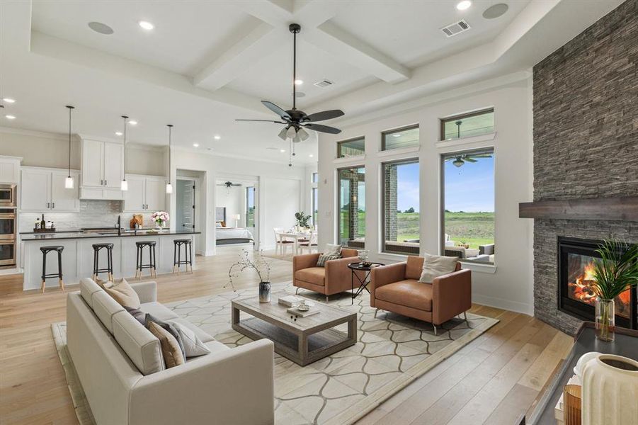 Living room with ceiling fan, a fireplace, beam ceiling, and light hardwood / wood-style flooring *VIRTUAL STAGING