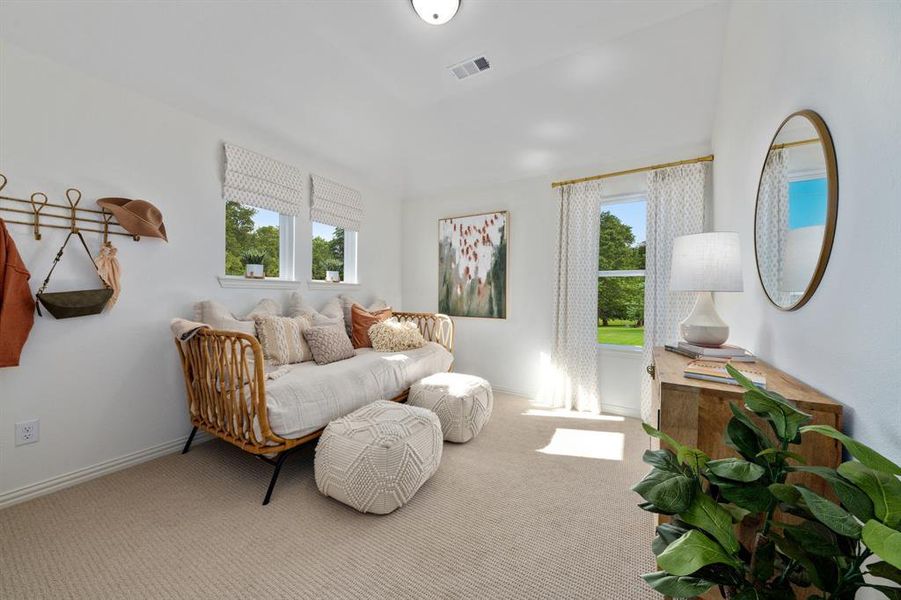 Bedroom featuring light carpet and plenty of natural light