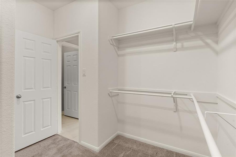 A view of your large primary walk-in closet