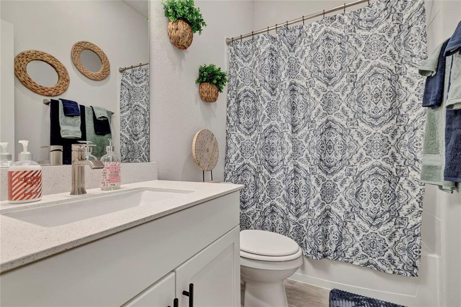 Pristine Bathroom - Bright, clean full bathroom conveniently located near the front door, study, and media room, offering comfort and convenience for guests.