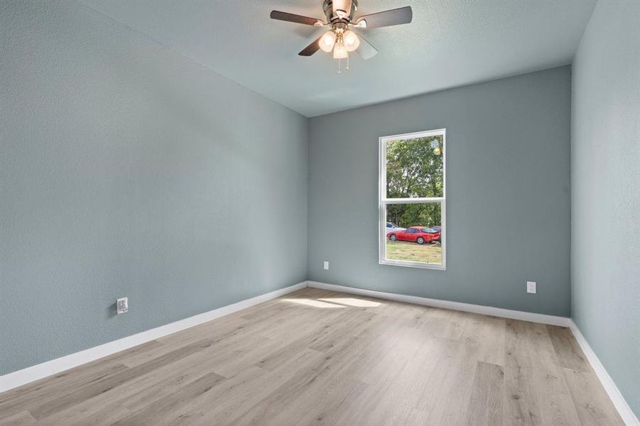 Spare room with ceiling fan and light hardwood / wood-style flooring