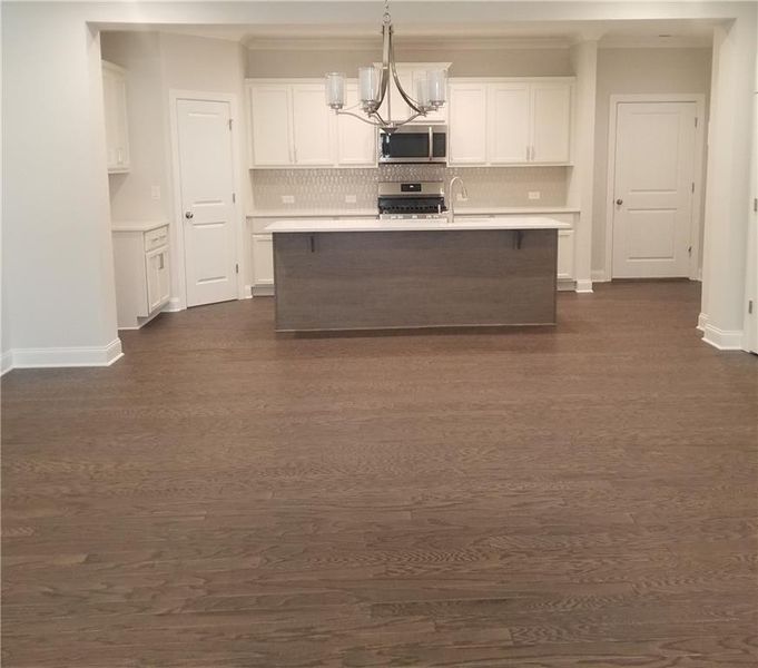 View of Dining and Kitchen - Hardwoods and Cove Molding throughout first floor