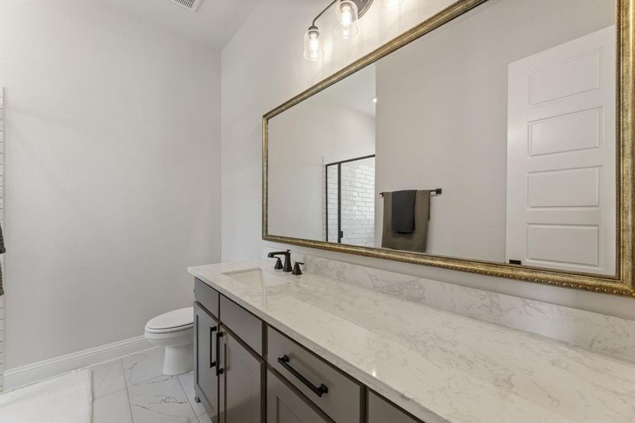 Bathroom featuring vanity and toilet