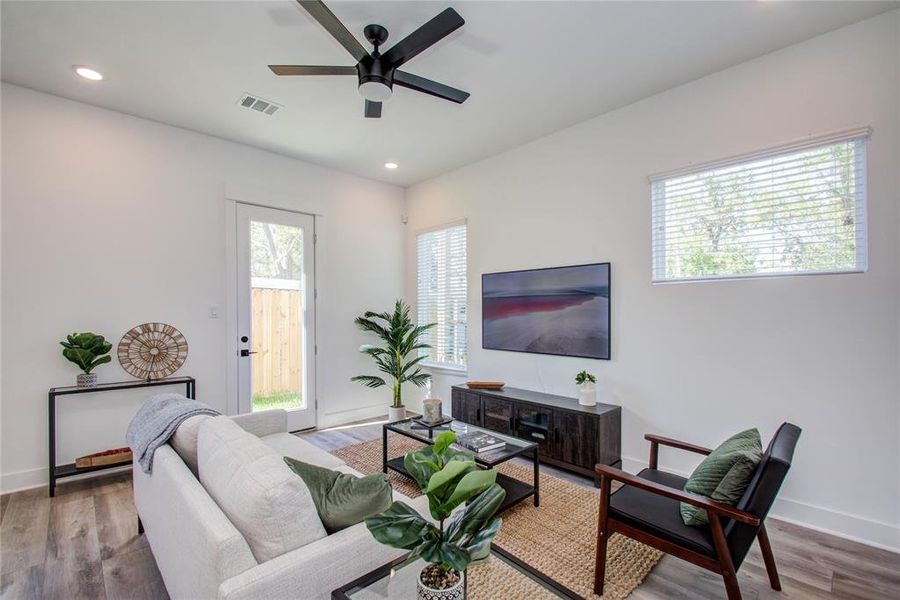 Spacious Living Room with high ceilings and tons of natural light! Model home photos - FINISHES AND LAYOUT MAY VARY! Ceiling fans are NOT INCLUDED!