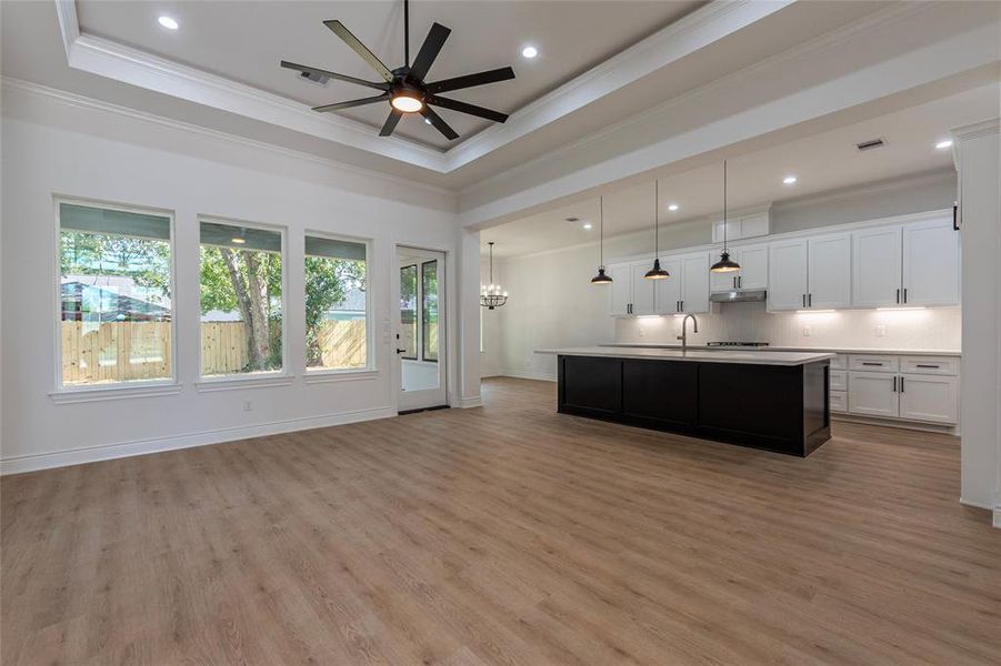 The family room offers plenty of natural light from windows.