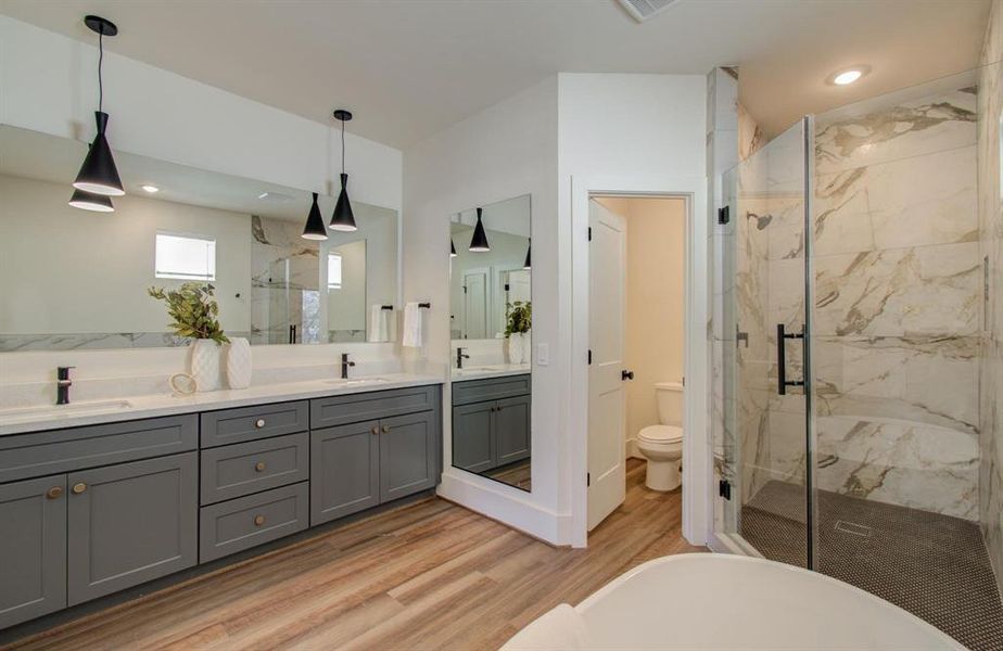 Full body mirror and linen closet are two. of the nice additions in the primary bathroom.