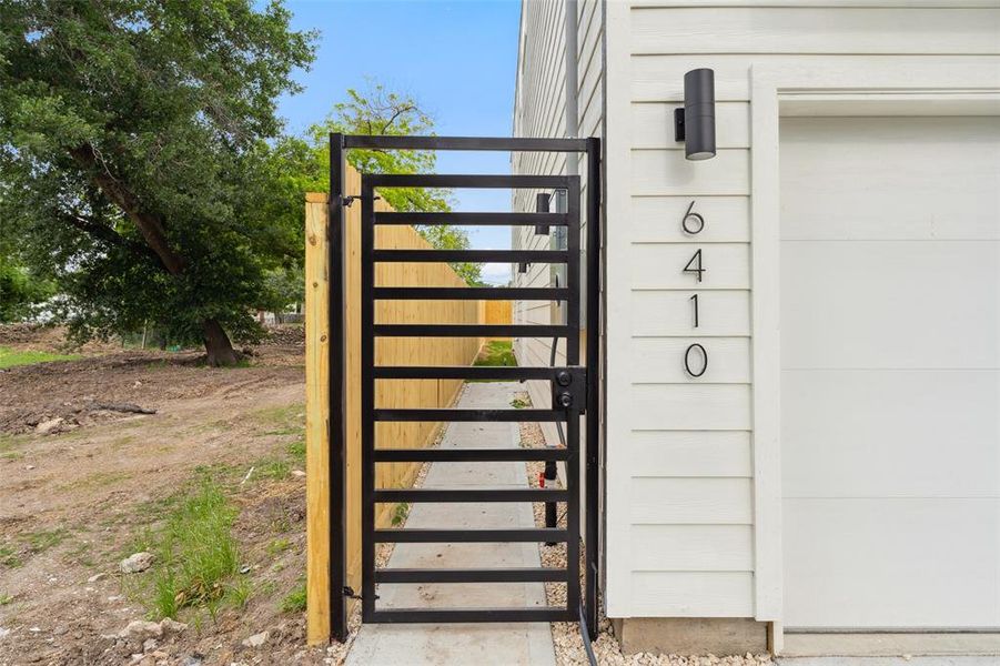 A private gate guiding to your front door and backyard, ensuring peace of mind and convenience