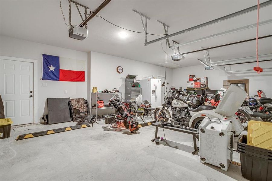 Oversized three car garage with three door openers, room for storage and access directly to back yard