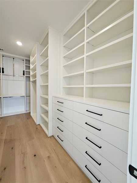 Spacious Primary Walk-In-Closet with built in drawers