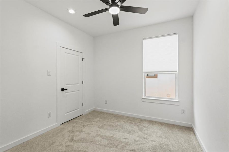 Unfurnished room with light carpet and ceiling fan