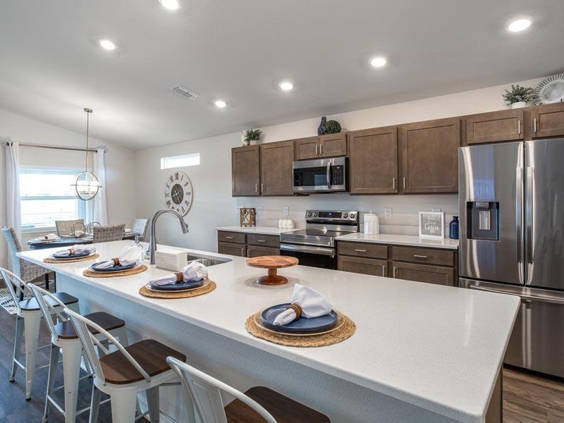 Enjoy a sunny, open kitchen with quartz counters, 36-inch cabinets, and Samsung appliances.