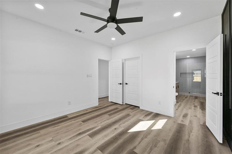 Unfurnished bedroom featuring ceiling fan and light hardwood / wood-style flooring